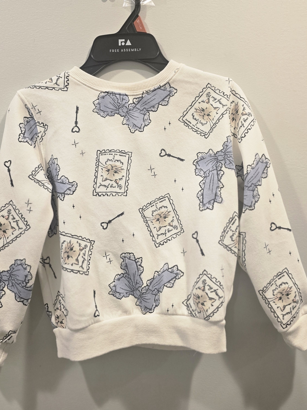 H&M Cream Sweatshirt with Blue and Tan Motifs
